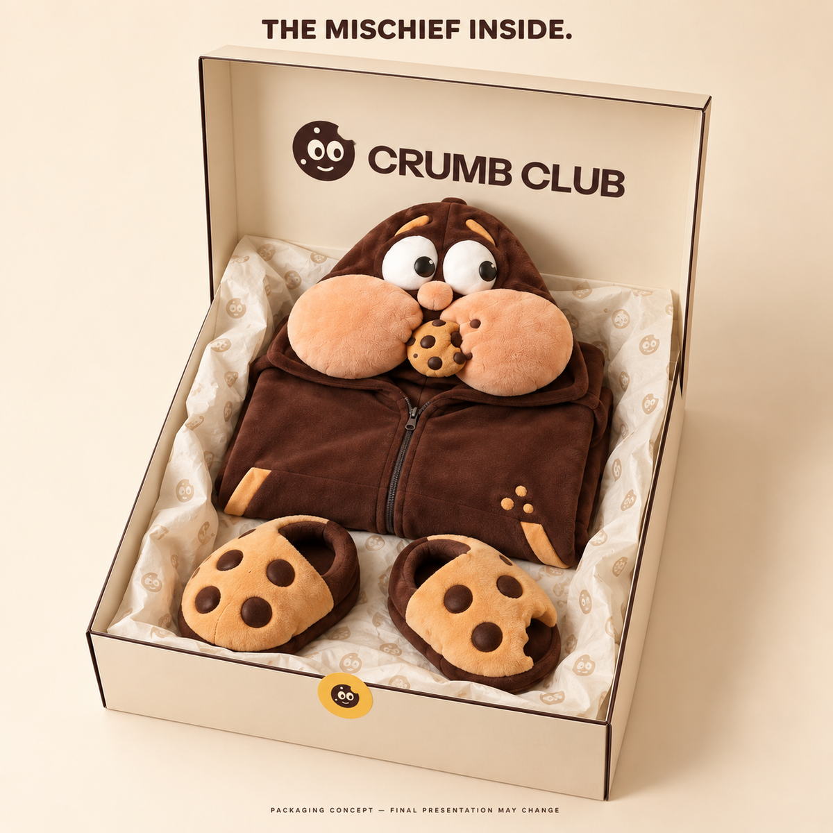 Packaging concept: a folded Goinfre onesie and separate cookie slippers in a Crumb Club box. Final presentation may change.